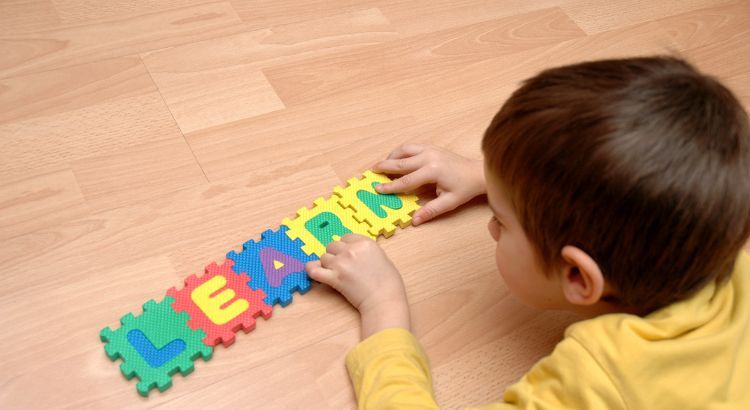 a young person putting together a Learn puzzle